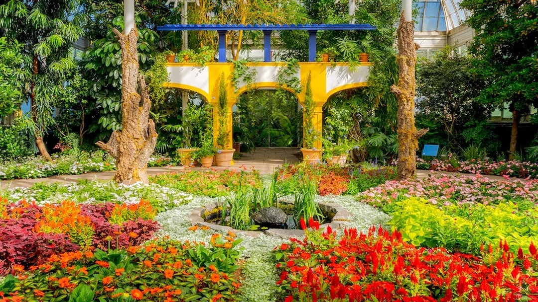 Colorful flower garden with archway inside New York Botanical Garden.