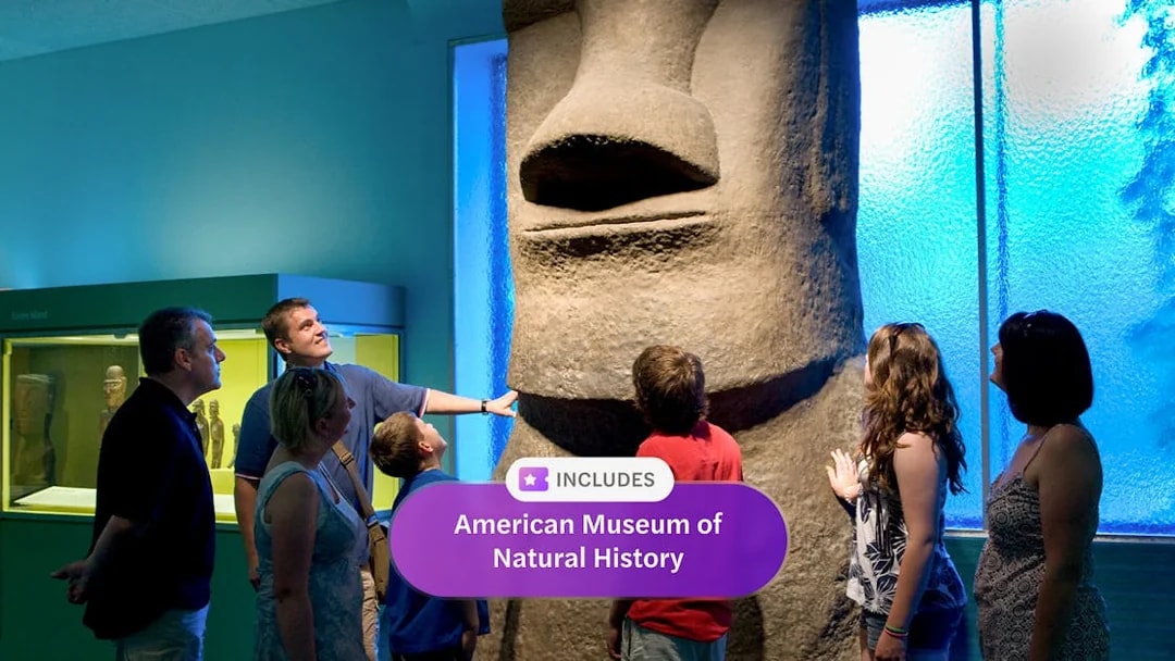 Visitors observing Easter Island statue at American Museum of Natural History exhibit.