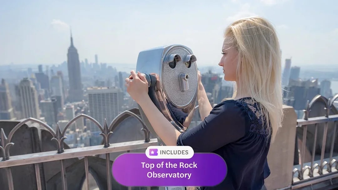 Person using binoculars at Top of the Rock Observatory, New York City skyline in view.