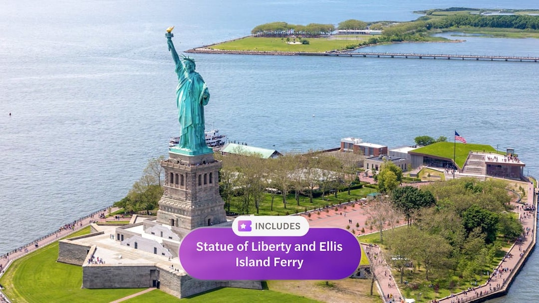 Statue of Liberty on Liberty Island, New York City, with Ellis Island ferry nearby.