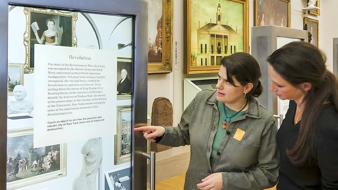 Visitors engaging with an exhibit at New York Historical Society.