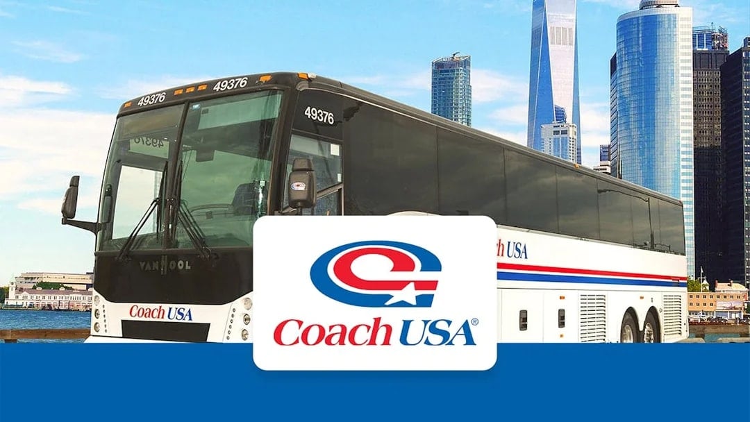 Coach USA bus with New York City skyline in the background.