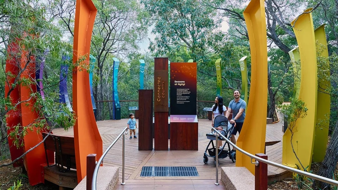 Ngilgi Cave entrance with colorful pillars and visitors exploring the Ancient Lands Experience.