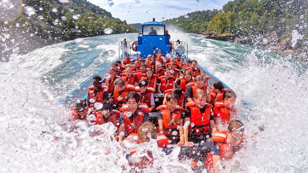 Guests enjoying a thrilling Whirlpool Jet Boat Tour in the Niagara Gorge, Canada.