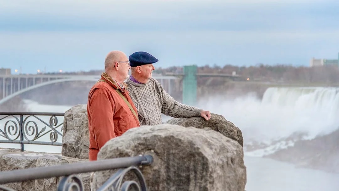 Visitors enjoying the view of Niagara Falls from a lookout point in Canada.