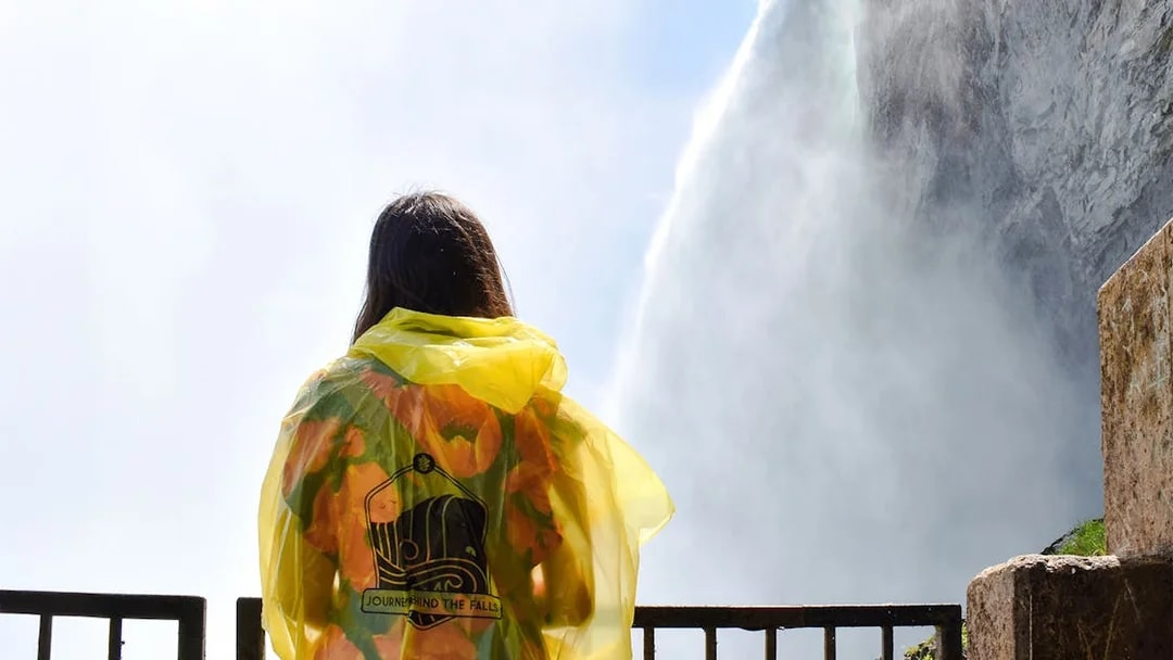 Woman in yellow poncho at Journey Behind the Falls, Niagara Falls.