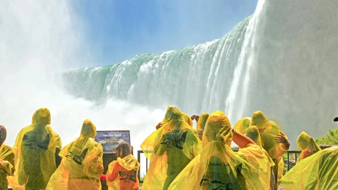 Visitors in yellow ponchos at Journey Behind the Falls, Niagara Falls, Canada.