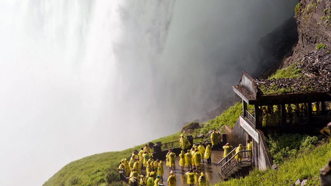 Tourists in yellow ponchos at Journey Behind the Falls, Niagara Falls.
