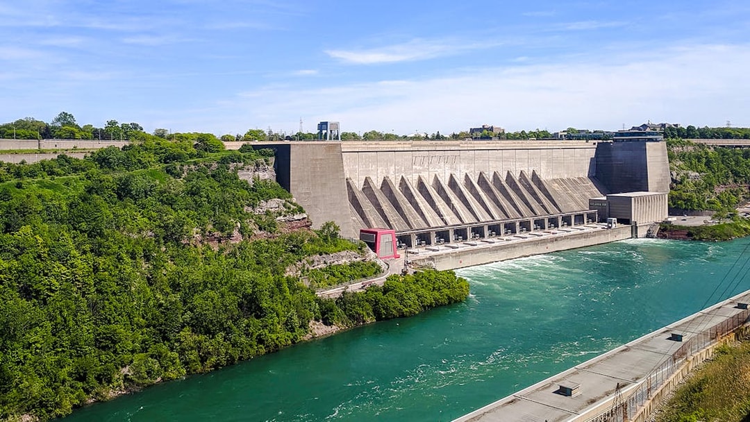 Robert Moses Power Station with flowing river, surrounded by greenery, Canada.