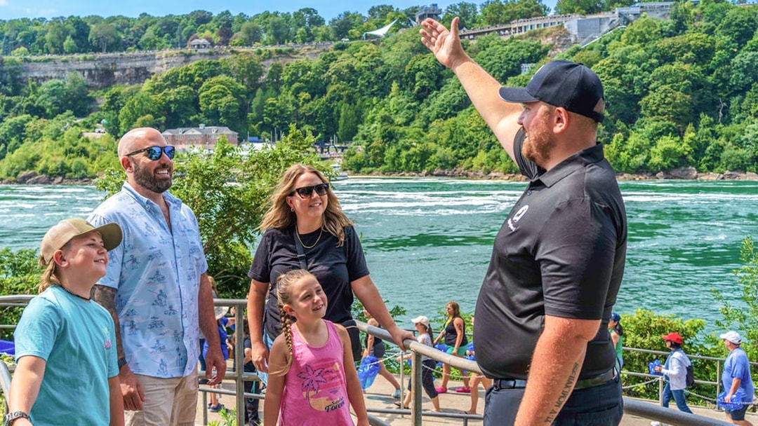 Tourists with guide overlooking Niagara Falls, Canada.