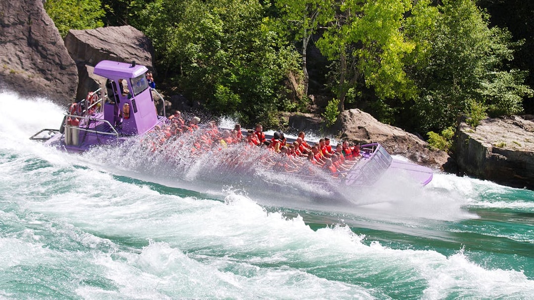 Guests on a Whirlpool Jet Boat navigating rapids in Niagara Gorge, Canada.