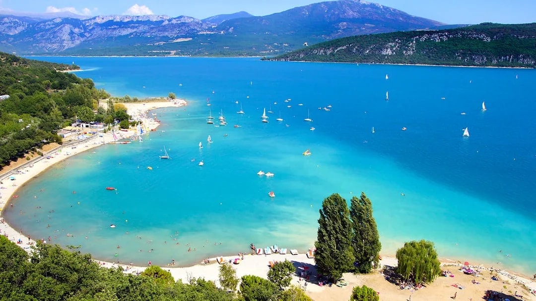 Aerial view of Lake Saint Croix with sailboats and beachgoers.