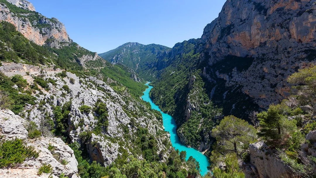 Verdon Gorge aerial view with turquoise river winding through rocky cliffs in Provence, France.