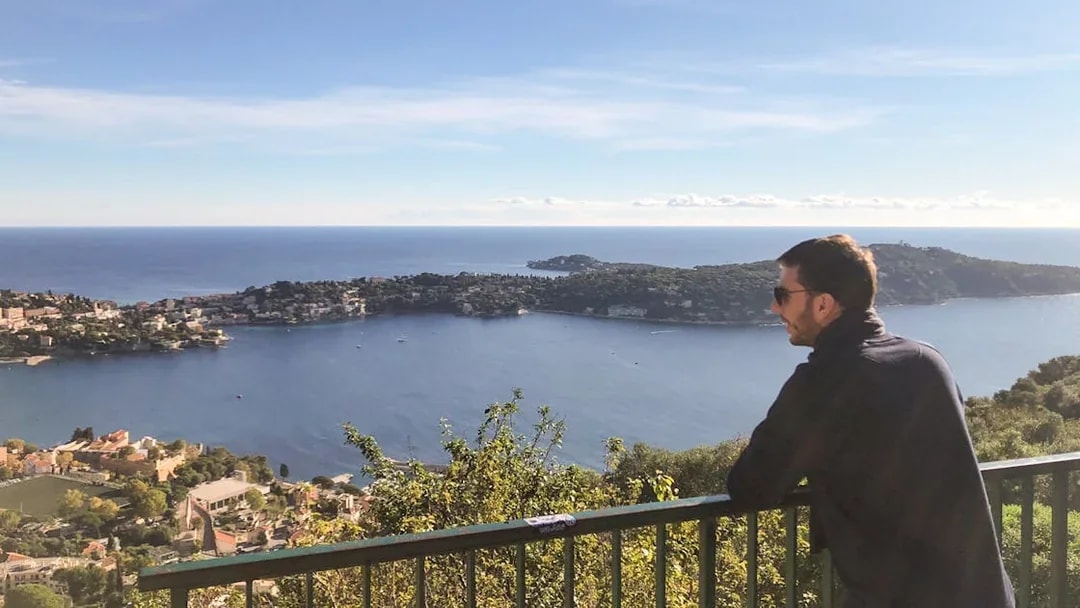 Man enjoying coastal view of Nice from a scenic overlook during a walking and driving tour.