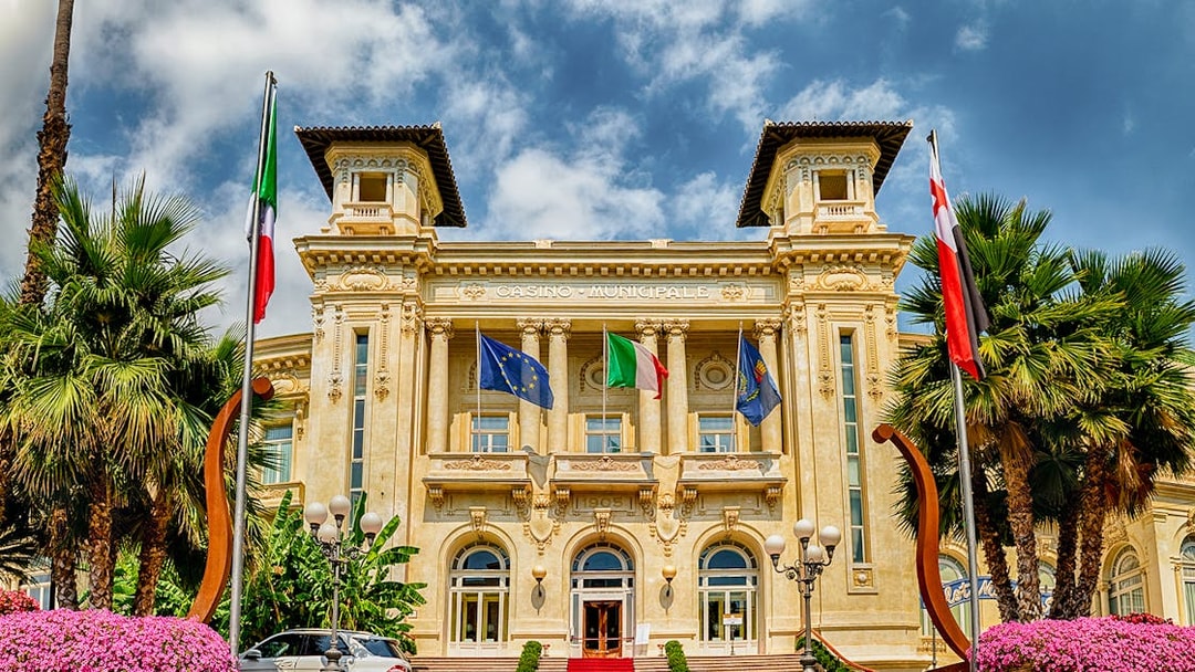 Casino Sanremo facade with flags, Italian Riviera tour.