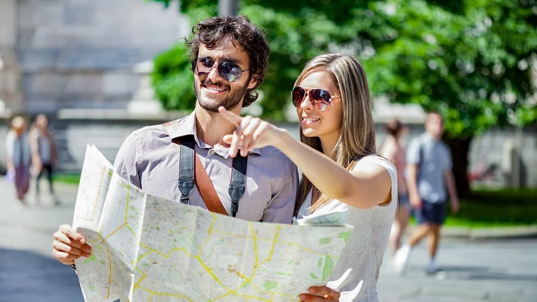 Tourists with a map exploring the Italian Riviera and Monaco.