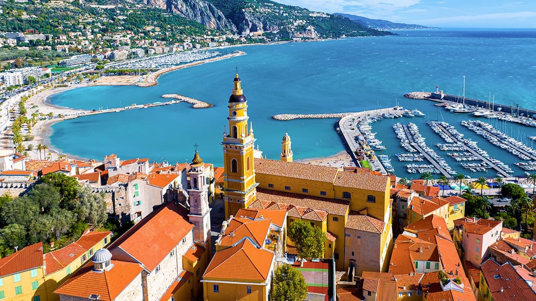 Aerial view of Menton with colorful buildings and marina on the Italian Riviera tour.