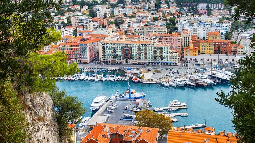 Nice harbor view with colorful buildings and yachts, ideal for a self-guided audio tour.