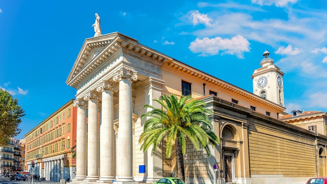 Nice city architecture with columns and clock tower on a self-guided audio tour.
