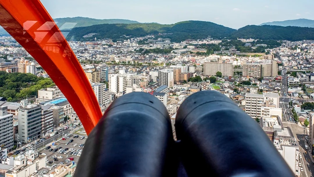 View of Kyoto cityscape from Kyoto Tower observation deck with binoculars.