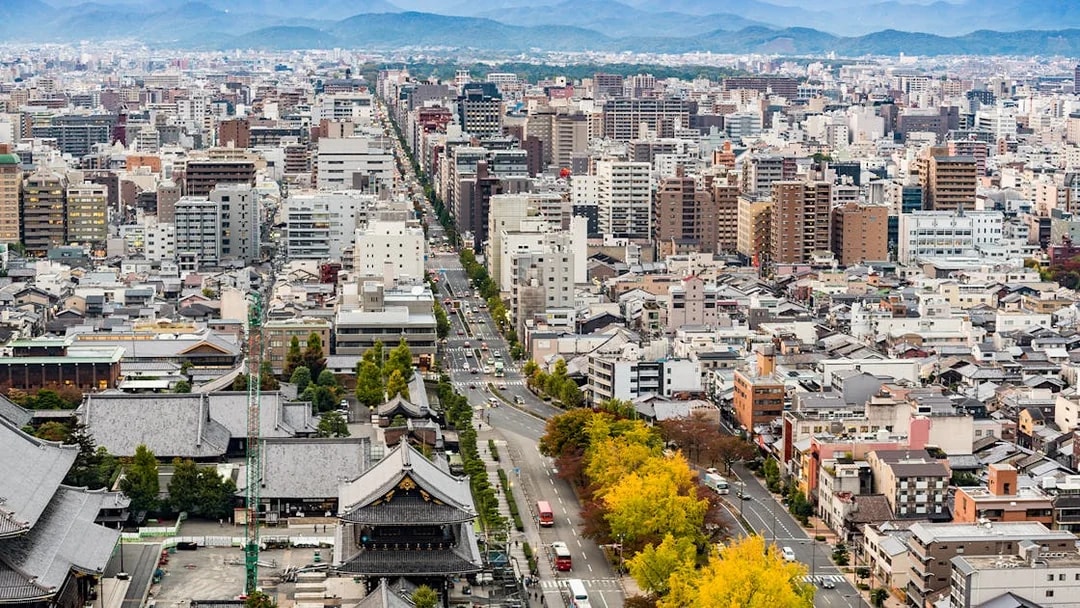 Kyoto cityscape view from Kyoto Tower with distant mountains.