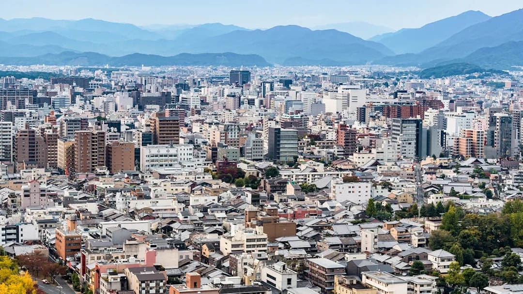 Kyoto cityscape with distant mountains viewed from Kyoto Tower.