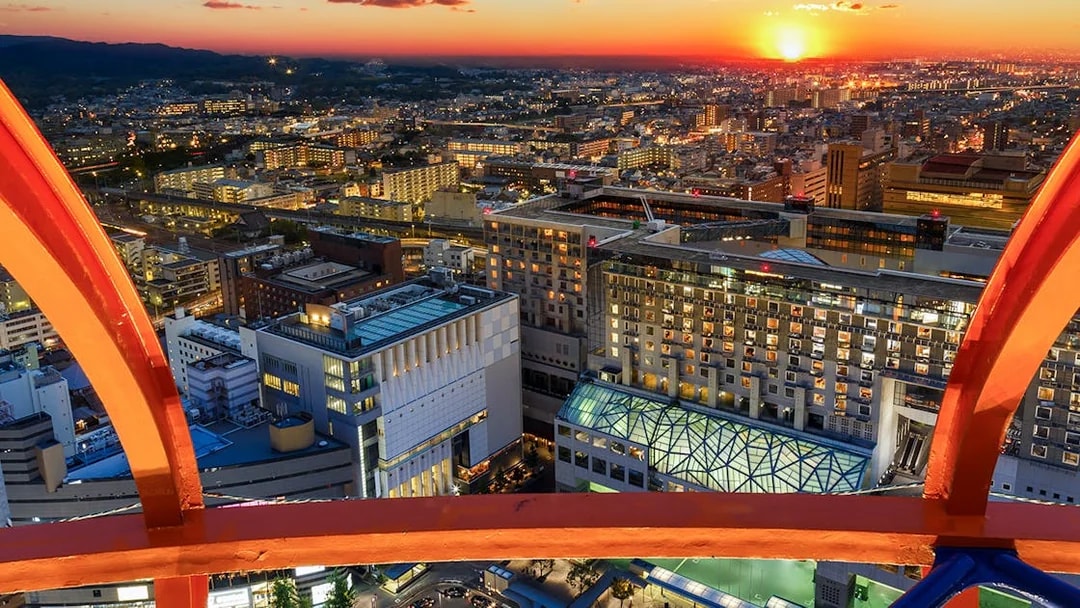 Kyoto cityscape from Kyoto Tower at sunset, highlighting urban architecture.