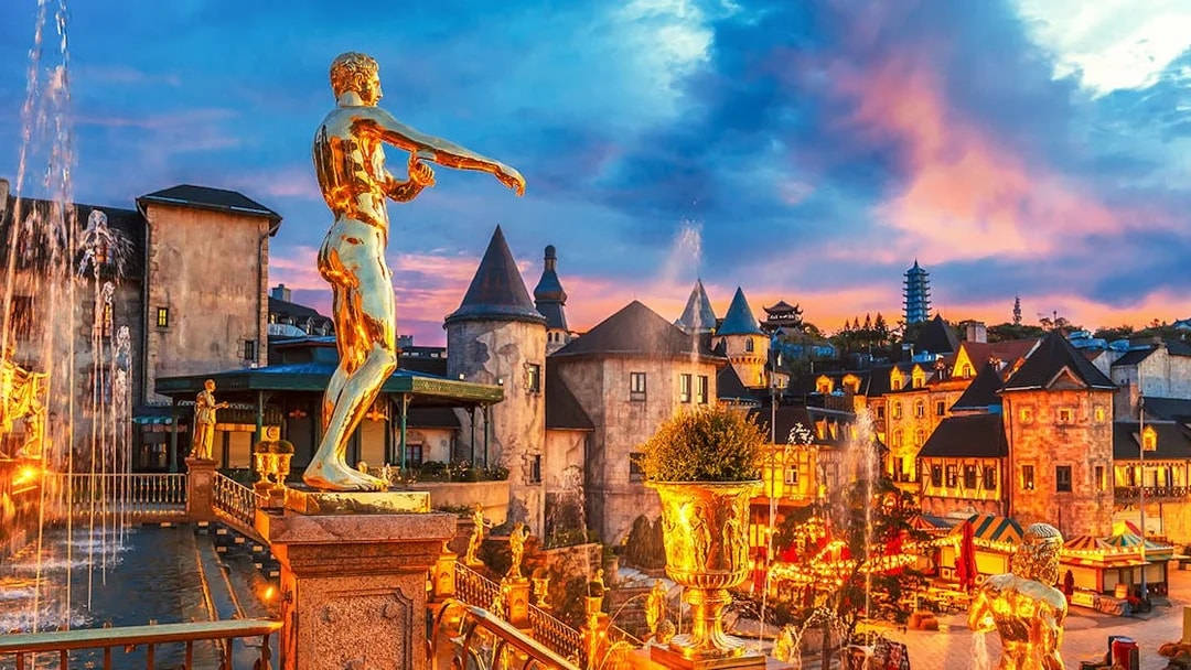 Fountain with golden statues in a French village at Ba Na Hills Park, Da Nang, Vietnam.