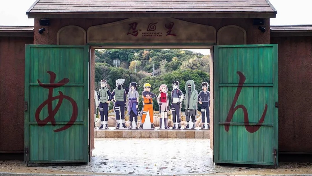Entrance to Nijigen No Mori Theme Park with Naruto and Boruto character cutouts.
