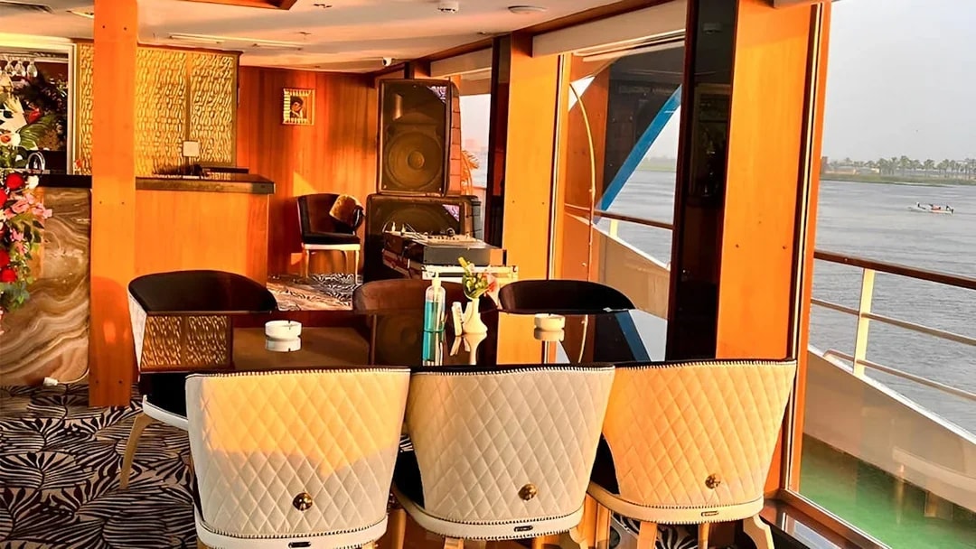 Dining area on a Nile dinner cruise ship in Cairo with river view.