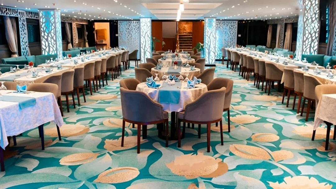 Elegant dining setup on a Nile dinner cruise in Cairo with decorated tables and chairs.