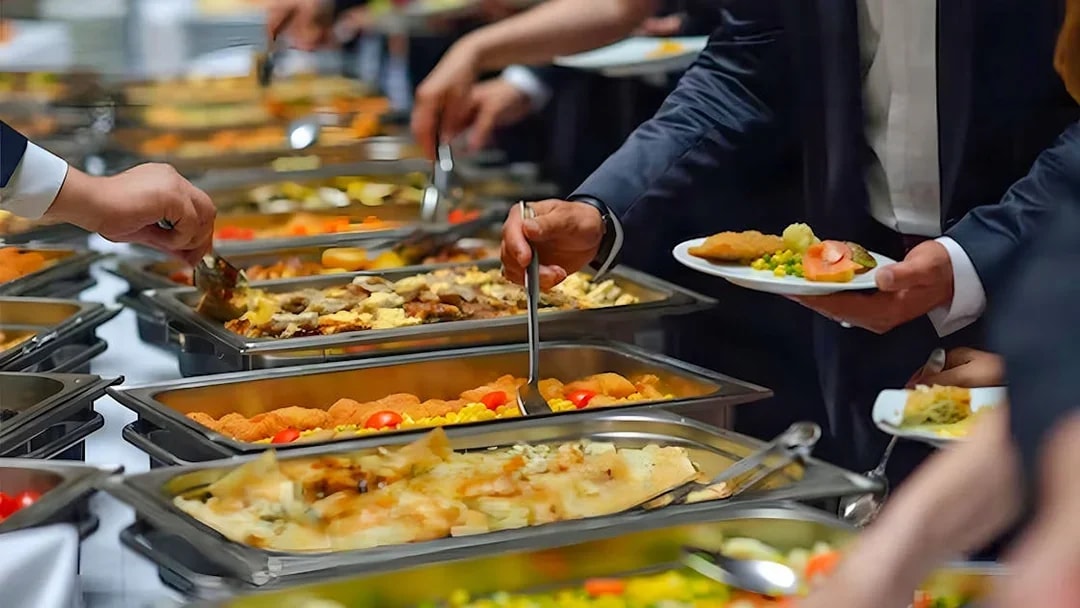 Buffet dinner on Nile River cruise in Cairo with guests serving food.