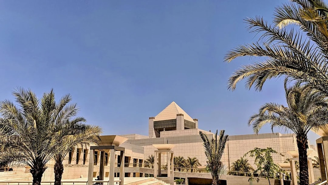 National Museum of Egyptian Civilization in Cairo with palm trees and modern architecture.