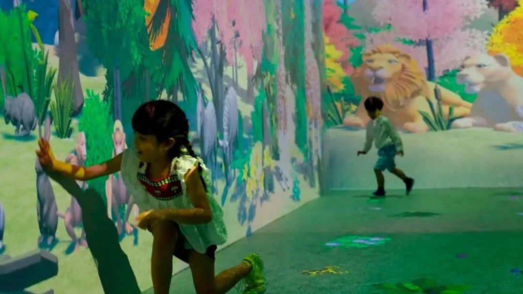 Children interacting with animal projections at Noah's Ark exhibit.