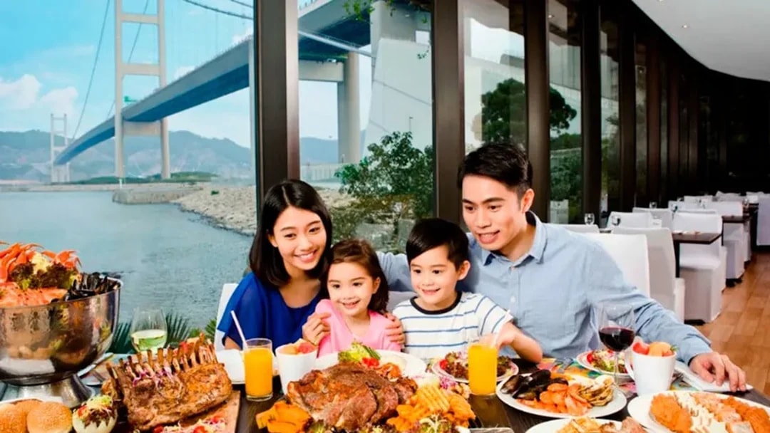Family dining with Tsing Ma Bridge view at Noah's Ark, Hong Kong.