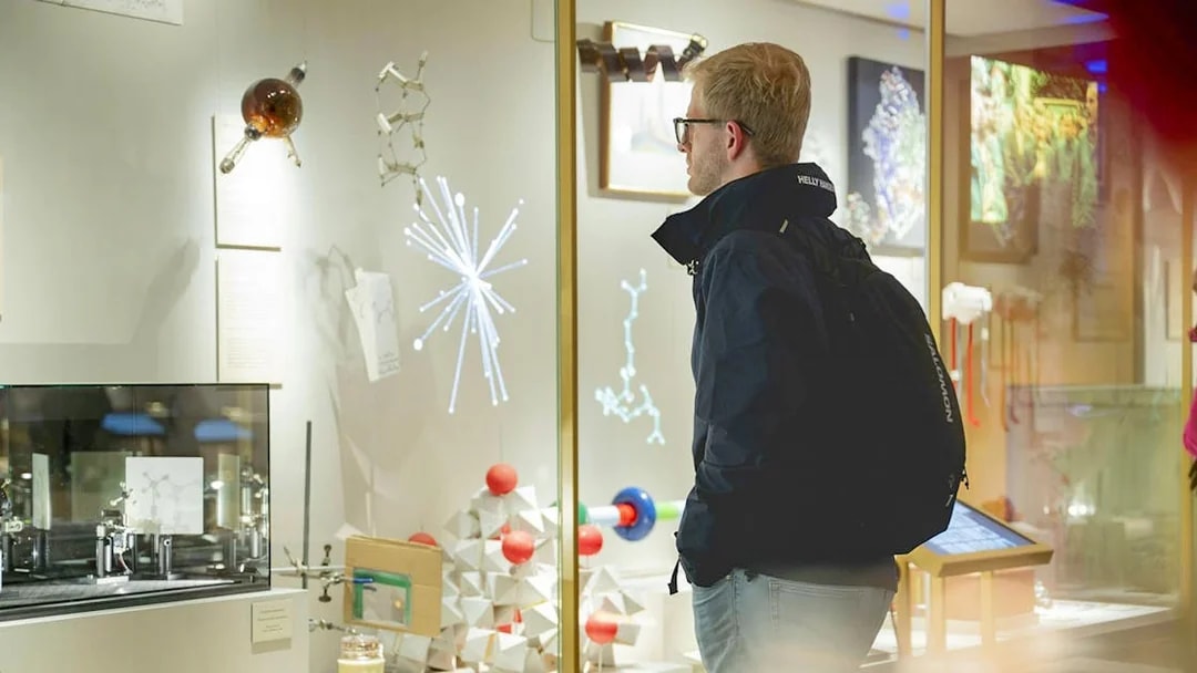 Visitor observing scientific exhibits at the Nobel Prize Museum.