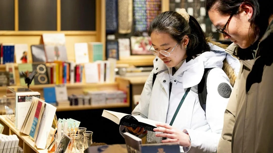 Visitors browsing books at the Nobel Prize Museum shop.