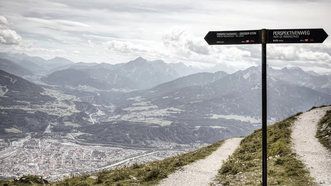 Path of Perspectives sign overlooking Innsbruck valley and mountains, Austria.
