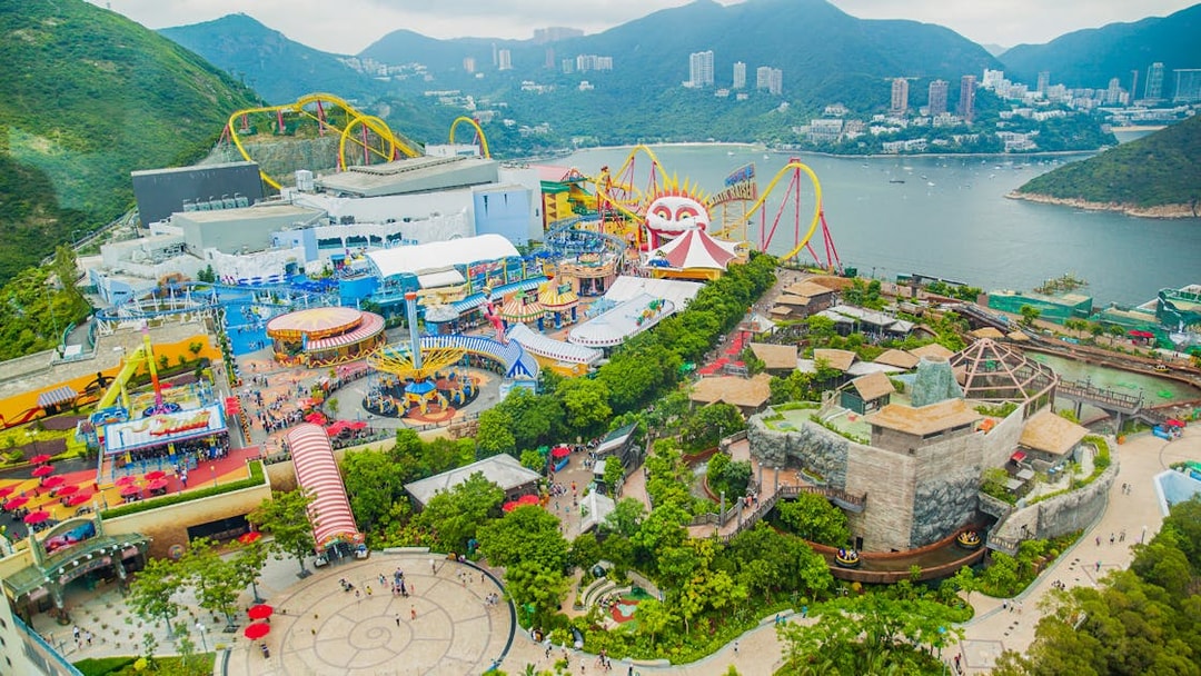 Aerial view of Ocean Park Theme Park with roller coasters and scenic bay in Hong Kong.