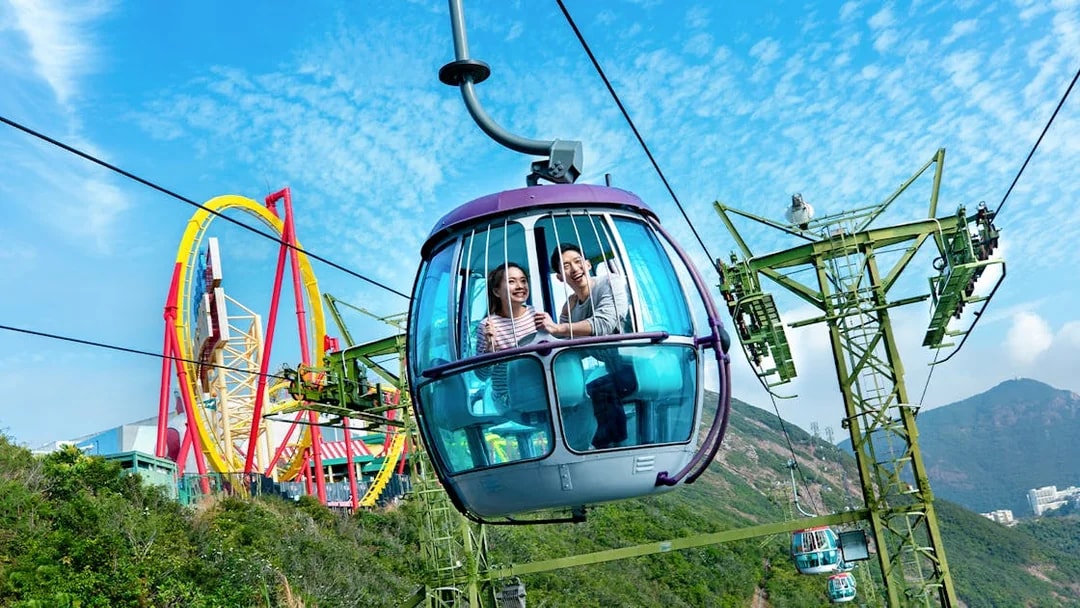 Cable car ride at Ocean Park Theme Park with roller coaster in the background.