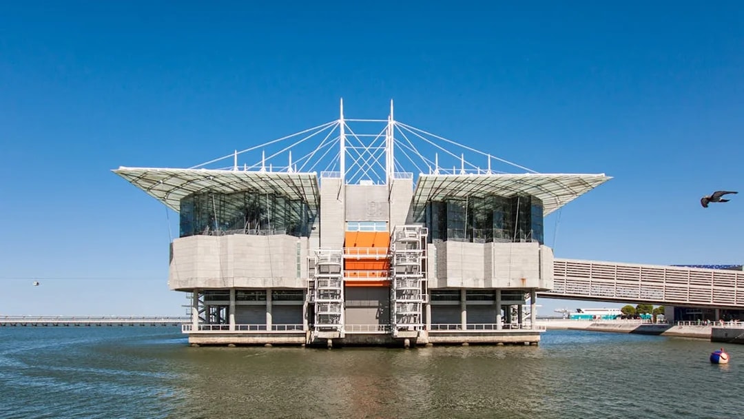 Lisbon Oceanarium building on water with clear blue sky, Portugal.