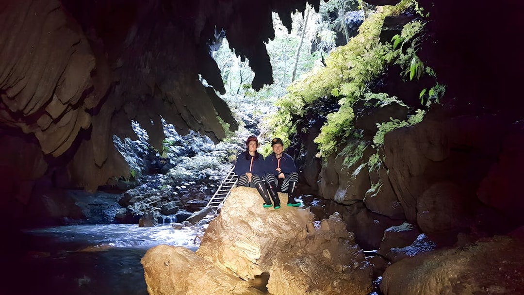 Visitors exploring Waitomo Glowworm Caves on a guided tour, New Zealand.