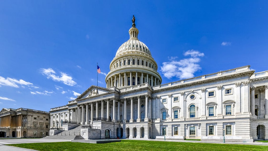 US Capitol Building with dome and American flag, Washington, DC.
