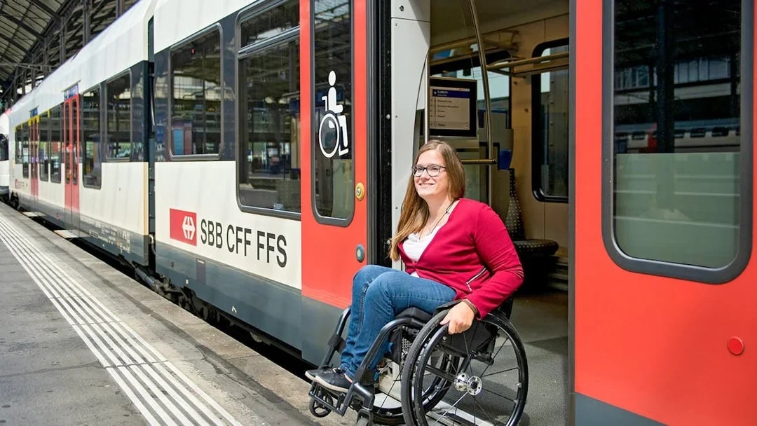 Train with wheelchair access at Geneva station platform.