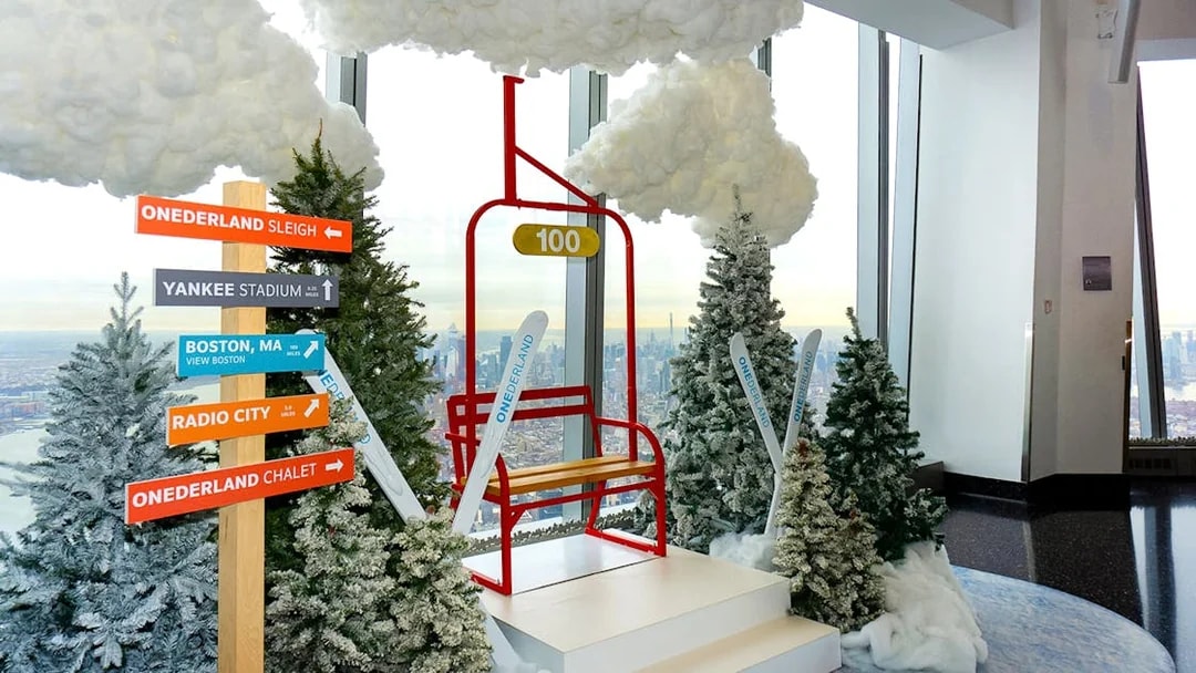 One World Observatory winter-themed display with directional signs and city view.