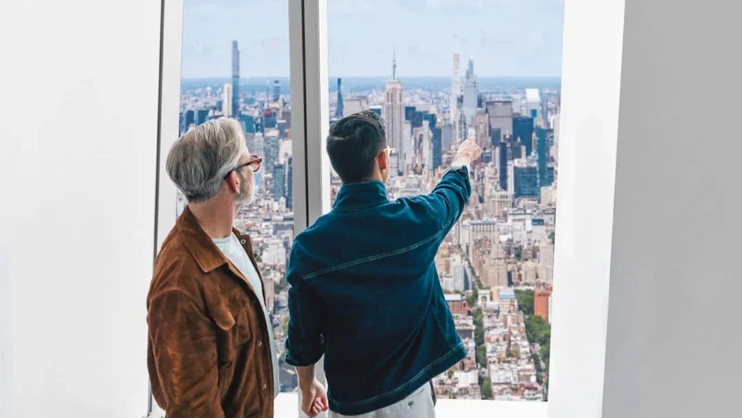 Visitors enjoying the New York City skyline from One World Observatory.