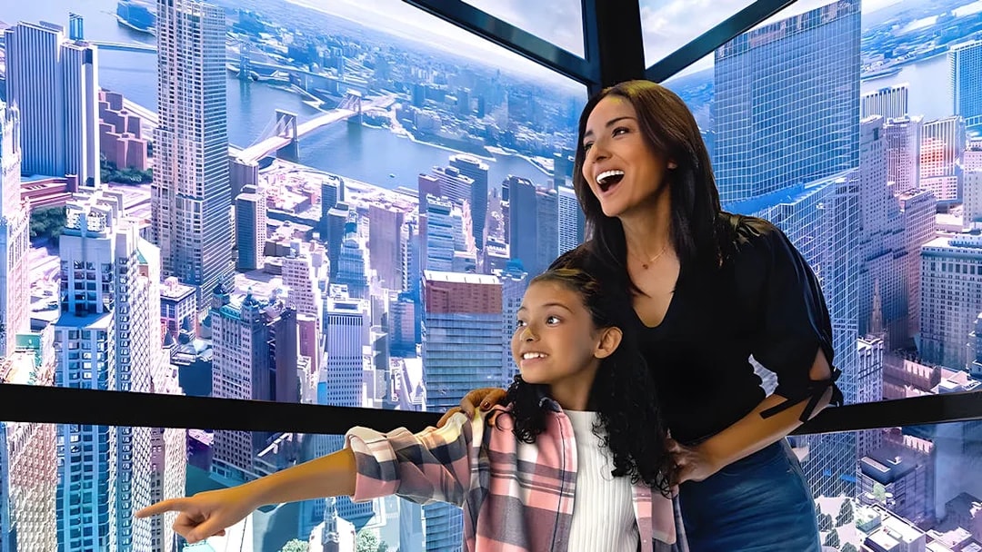 Visitors enjoying digital skyline display in One World Observatory elevator, New York City.
