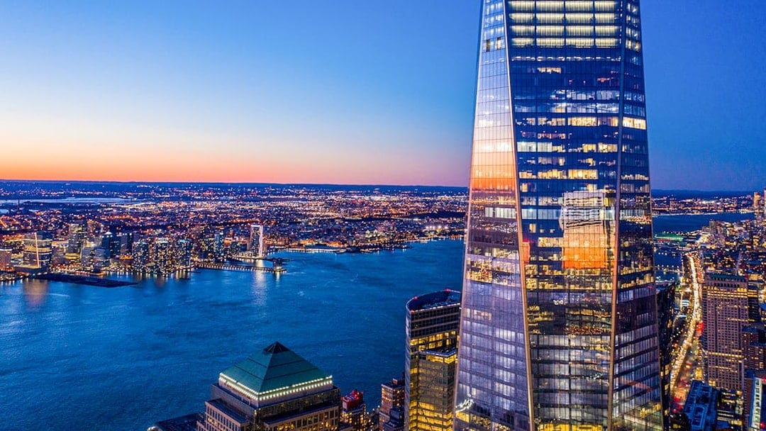 One World Observatory view at sunset over New York City skyline and Hudson River.