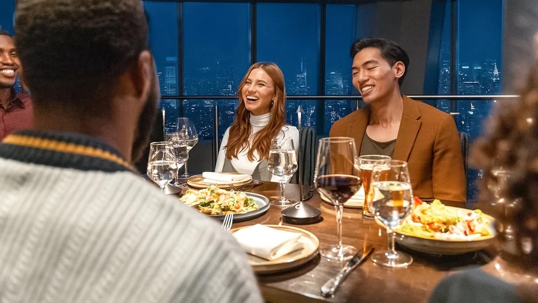 Dining experience at One World Observatory with city skyline view.