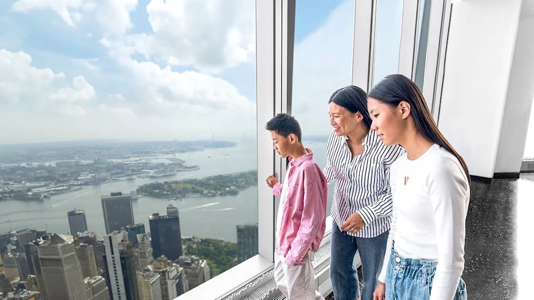 Visitors enjoying New York skyline view from One World Observatory.